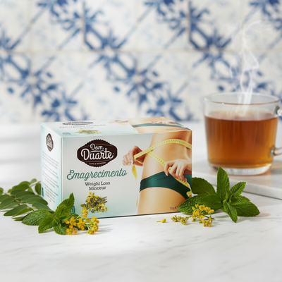 Box of 'Dom Duarte' weight loss product with a glass of tea and mint leaves on a white surface.