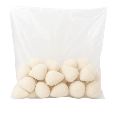 Transparent plastic bag filled with frozen Brazilian mini chicken coxinhas with Catupiry cheese, teardrop-shaped, breadcrumb-coated, uncooked, ready-to-fry.