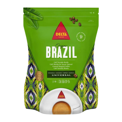 A package of Delta brand Brazil coffee, ground, in a green bag with a white and green pattern. The bag indicates a weight of 220g and suggests a universal grind.