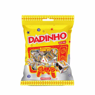 A packaged candy named 'DADINHO' with peanuts visible through the clear plastic, set against a yellow background with decorative elements.