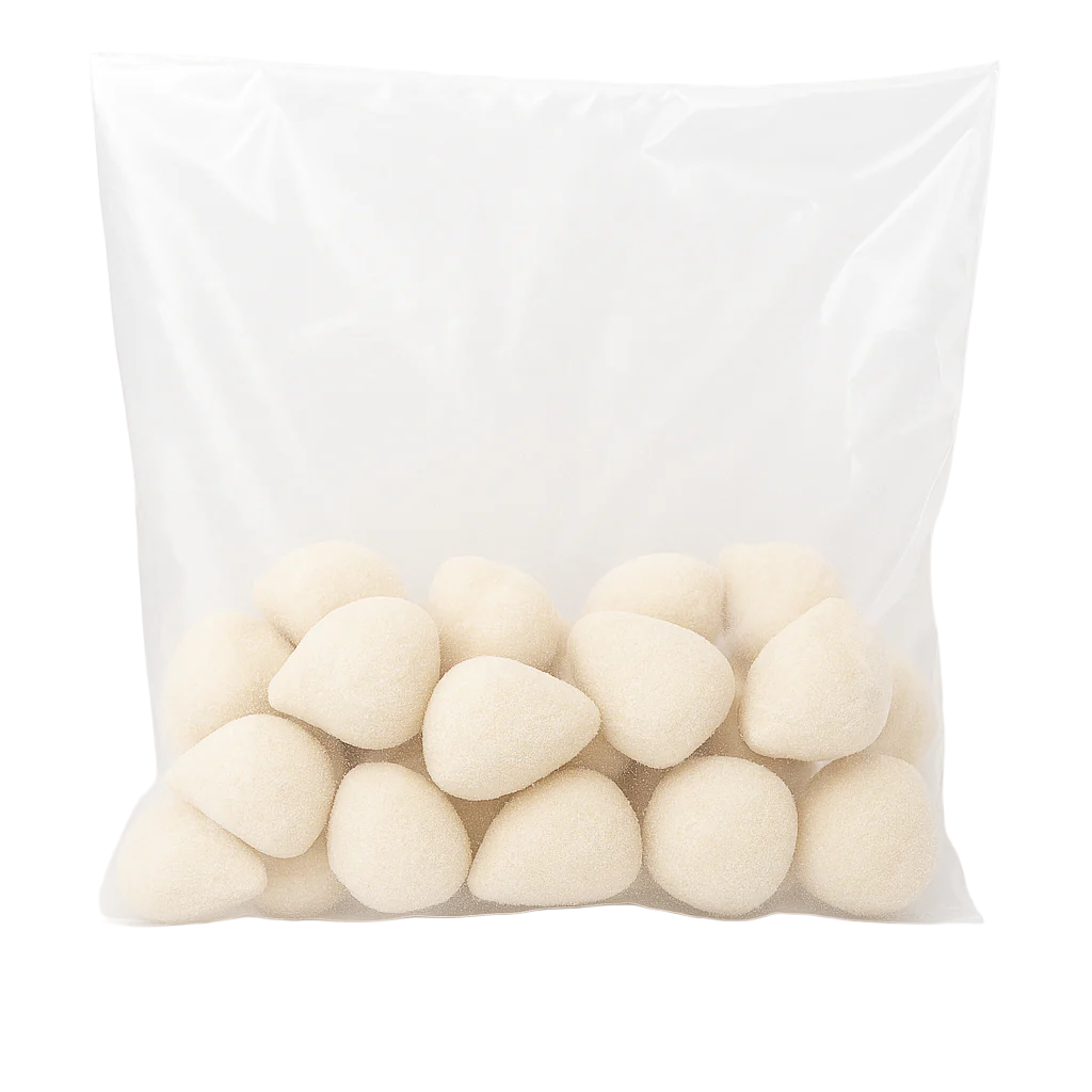 Transparent plastic bag filled with frozen Brazilian mini chicken coxinhas with Catupiry cheese, teardrop-shaped, breadcrumb-coated, uncooked, ready-to-fry.