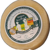 Round cheese with a label on a dark surface