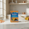 Renata Cenoura product packaging on a kitchen counter with carrots and a cake in the background